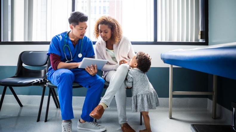 Doctor helping patient with tablet device